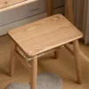 manna-oak-square-stool-seat-detail Detail close up of solid oak square stool seat showing rounded corners, wood grain and H stretcher joinery.