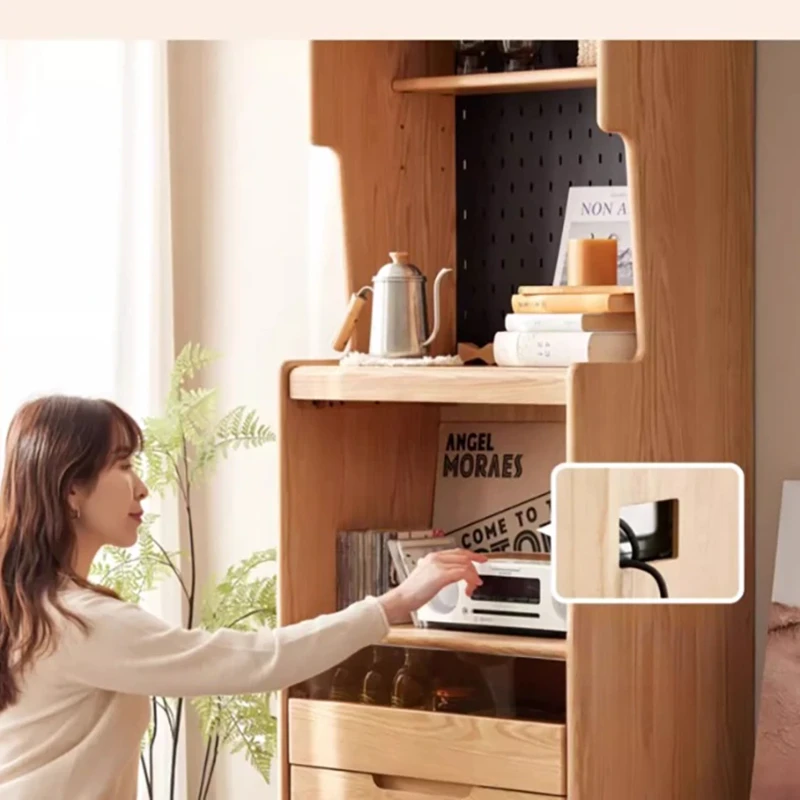 manna-oak-tall-sideboard-pegboard-storage-living-room Lifestyle view of an oak tall sideboard with black pegboard panel, coffee station and storage drawers standing in a bright styled living room.