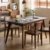 manna-walnut-dining-chair-living-room-cy1009 Four solid walnut dining chairs with curved backs arranged around a black top dining table in a warm dining room.