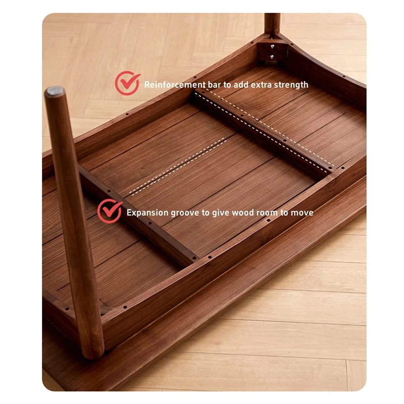 Detail view of a walnut dining table underside showing the concealed reinforcement bar and the expansion groove that lets the wood move.