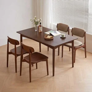 manna-walnut-rectangular-dining-table-lifestyle Lifestyle scene of a rectangular walnut dining table with four chairs beside a large window with blinds.
