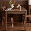 manna-walnut-rectangular-dining-table-width-options-table-dimensions Table dimensions image of a walnut dining table showing 75, 80 and 85 centimeter width options with flowers on top.
