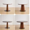 manna-walnut-round-dining-table-120cm-lifestyle Lifestyle scene of a round walnut dining table with a tapered base shown in four angles on light oak flooring.