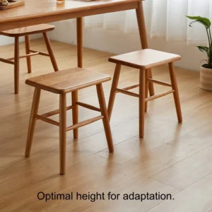 manna-walnut-square-stool-pair-dining-room Two solid walnut square stools with rounded seats standing under a wooden dining table on a light oak floor.