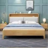 Beech platform bed front view with cushion upholstered headboard in a styled bedroom