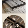 Black bed frame slatted base structure detail showing solid wood support layout