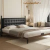 black-leather-tufted-headboard-walnut-platform-bed Walnut platform bed with black leather tufted headboard in a modern bedroom setting