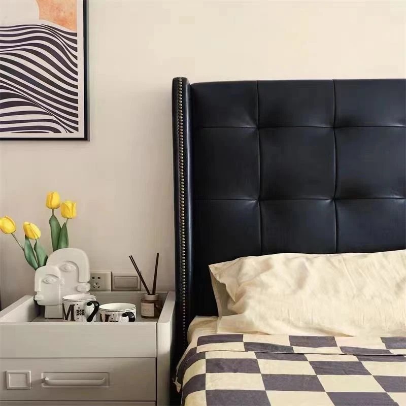 Black leather upholstered platform bed with tall button tufted wingback headboard