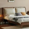 black-walnut-bed-cream-leather-pillow-headboard Black walnut bed with cream leather pillow headboard front view in a styled bedroom
