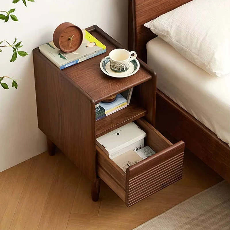 Black walnut nightstand drawer open showing storage in a bedroom scene