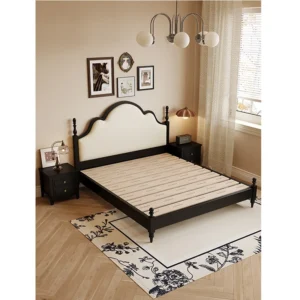 Black French retro bed frame with arched cream upholstered headboard in a vintage bedroom