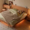 Cherry platform bed with LED ambience lighting glowing in a lifestyle bedroom scene