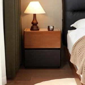 Cherry and black walnut two drawer nightstand beside a bed in a warm bedroom scene