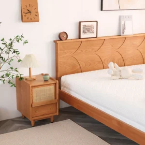 Cherry rattan door nightstand beside a bed in a warm bedroom scene