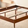 Cherry wood bed frame support structure detail showing center rail and legs