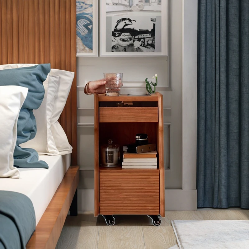 Cherry wood narrow rolling nightstand with glass top in bedroom