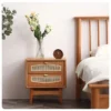 Cherry wood nightstand with bedside lamp in a warm bedroom scene