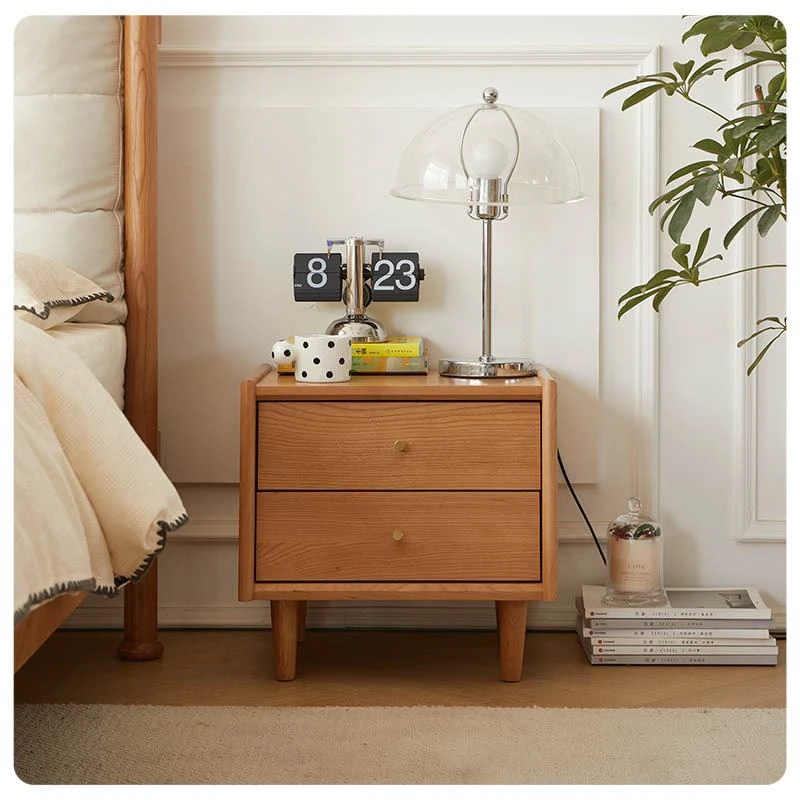 cherry-wood-nightstand-lifestyle-scene-reading-in-bed Cherry wood two-drawer nightstand beside the bed in a lifestyle reading scene