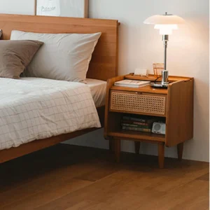 Cherry wood nightstand with rattan drawer as bedside table in bedroom