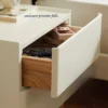 Cream nightstand drawer anti-fall enclosure detail on the inner rail