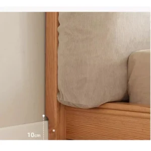 Natural oak platform bed with cushion headboard showing baseboard gap design