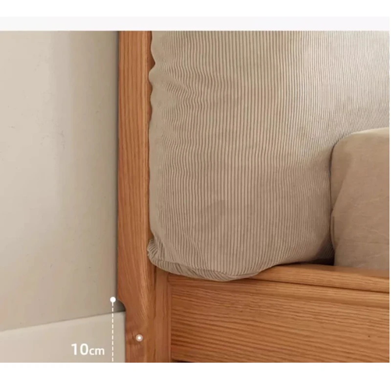 natural-oak-platform-bed-cushion-headboard-bedroom Natural oak platform bed with cushion headboard showing baseboard gap design