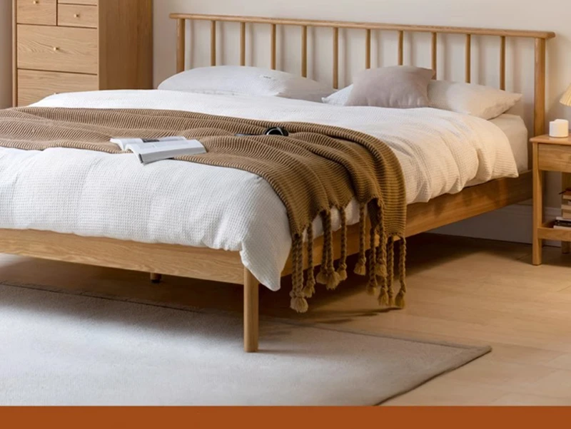Natural oak spindle platform bed frame styled in a cozy bedroom with soft bedding