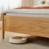 natural-oak-upholstered-headboard-gas-lift-storage-bed Natural oak gas lift storage bed with upholstered headboard in a styled bedroom setting