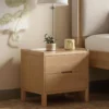 Oak 2 drawer bedside table front view with green plant decor