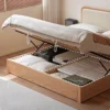 Oak gas lift storage bed with cream upholstered headboard shown from the front