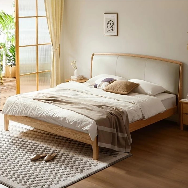 Oak bed frame with cream upholstered headboard in a styled bedroom