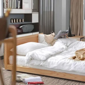 Oak platform bed frame with fabric backrest in a low profile lifestyle scene