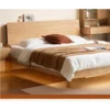 oak-bed-frame-side-view-lifestyle-scene Solid oak platform bed side view in a warm lifestyle bedroom scene with underbed storage