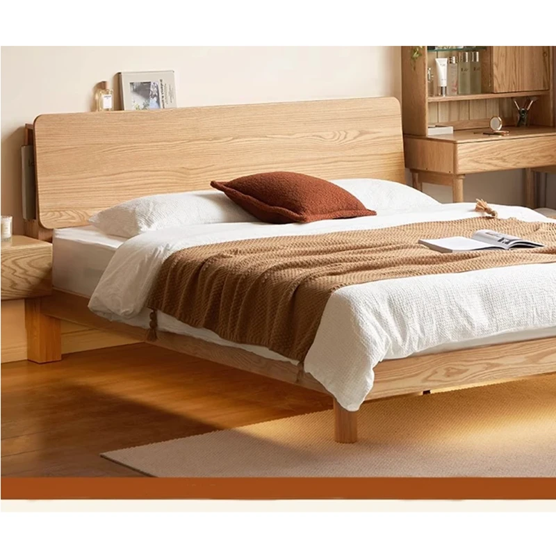 oak-bed-frame-side-view-lifestyle-scene Solid oak platform bed side view in a warm lifestyle bedroom scene with underbed storage
