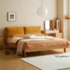 Oak bed frame with yellow cushion fabric headboard in a bright bedroom scene