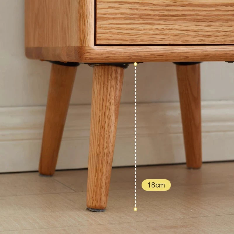 Oak nightstand drawer with round brass knob close up detail view