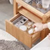 Oak nightstand fluted drawer open showing perfume and storage