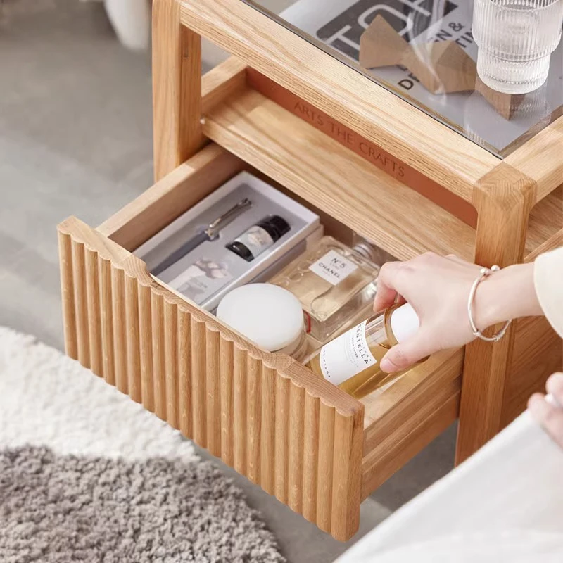 Oak nightstand fluted drawer open showing perfume and storage