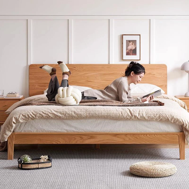 oak-platform-bed-bedroom-lifestyle-scene Natural oak bed frame with curved headboard in a bedroom lifestyle scene
