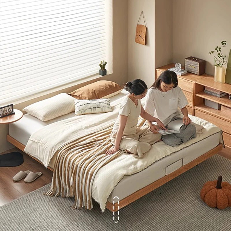 Oak floating platform bed with slatted base in a warm lifestyle bedroom scene