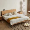 Oak platform bed with rounded headboard in a master bedroom lifestyle scene