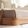 oak-platform-bed-tufted-headboard-lifestyle-scene Oak platform bed with tufted cushion headboard in a soft lifestyle scene