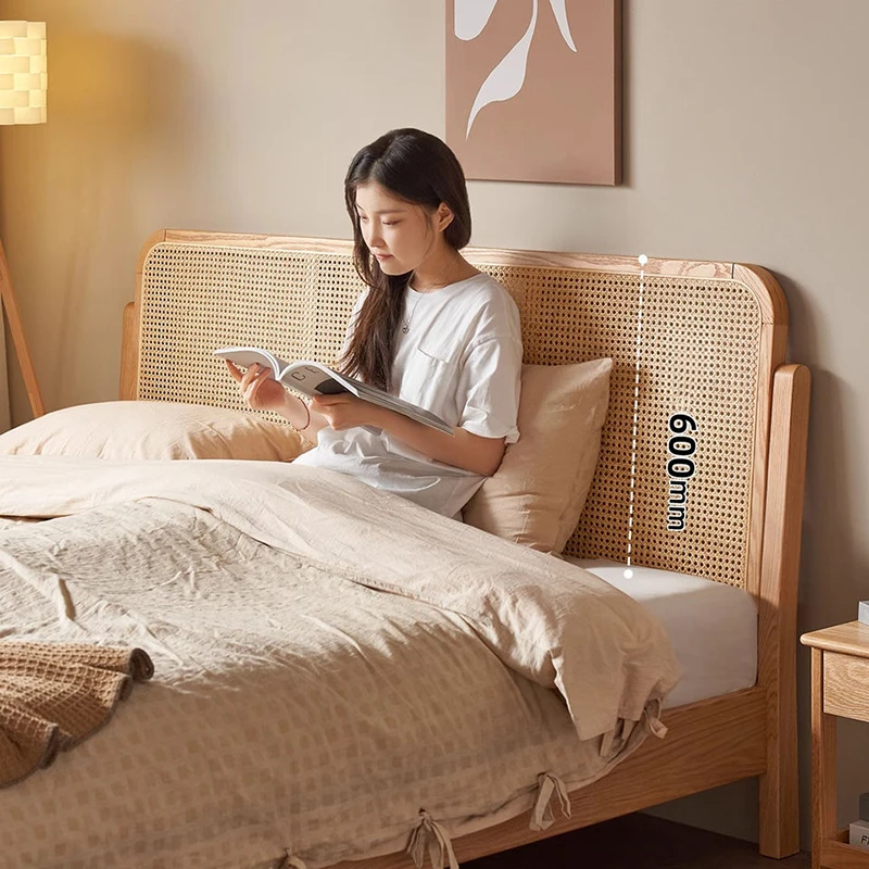 oak-rattan-headboard-bed-lifestyle-scene Oak platform bed with woven rattan headboard in a warm lifestyle scene