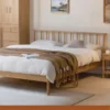 Oak spindle headboard bed front view from another angle in daylight
