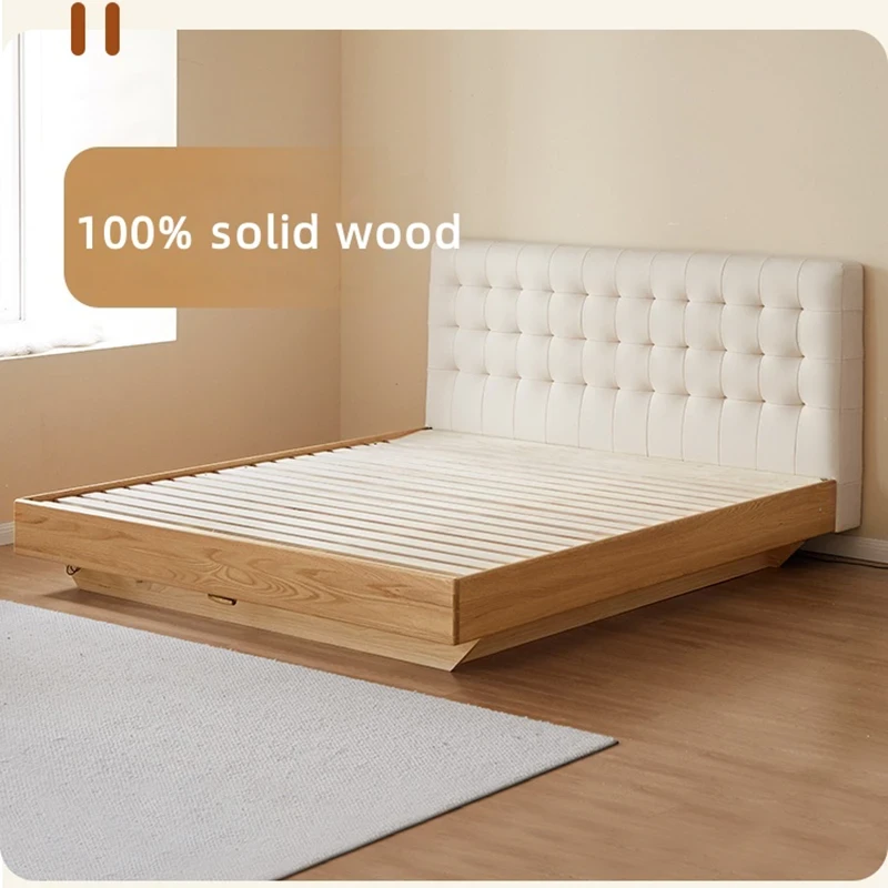 Solid oak bed frame with cream tufted headboard and wood slatted base in a bright room