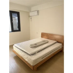 solid-oak-platform-bed-frame-master-bedroom Solid oak platform bed frame in a master bedroom with warm ambient lighting