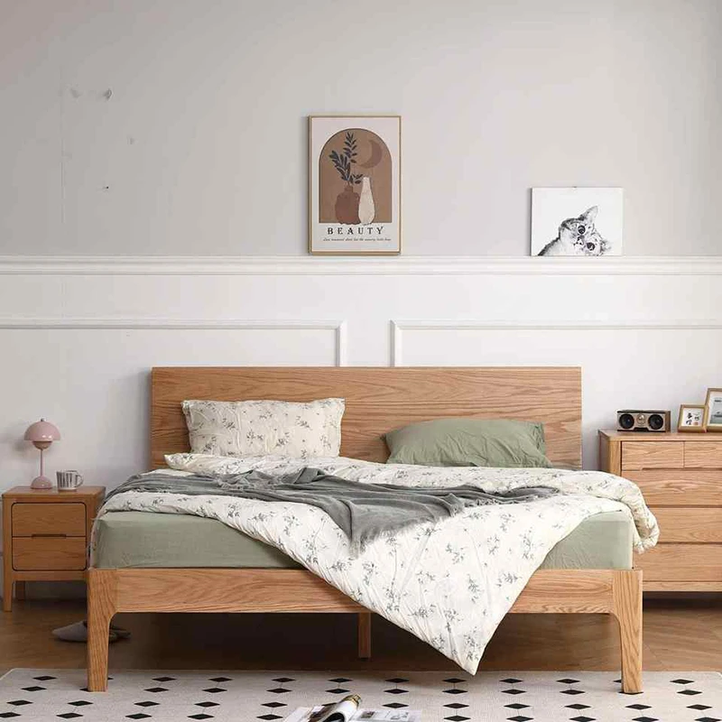 Solid oak platform bed shown from the front in a bright bedroom setting