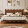 Solid walnut bed frame with wavy headboard front view in a styled bedroom