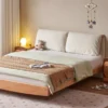 solid-wood-platform-bed-fabric-headboard-bedroom Solid wood platform bed with cream fabric headboard in a warm bedroom scene