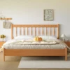 Cherry wood platform bed frame with wavy spindle headboard front view